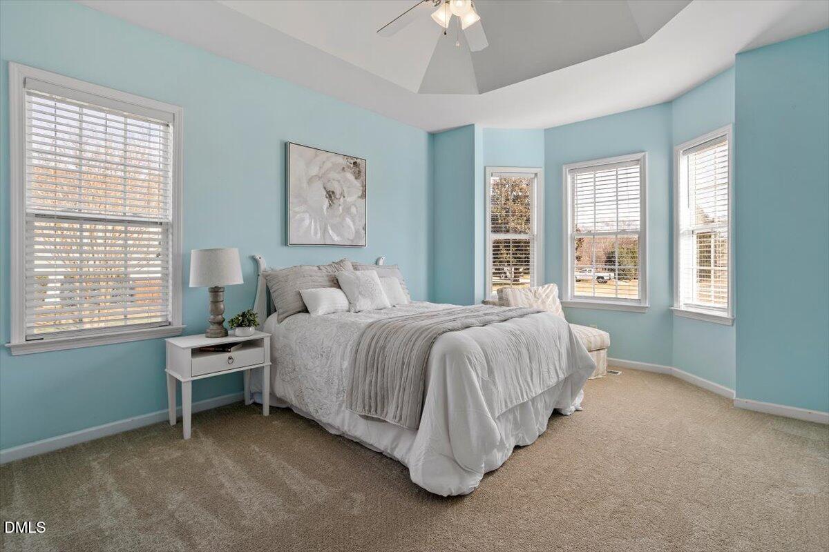 119 Victory Circle Willow Spring, NC 27592 - Photo 9 of 33 a spacious bedroom with a bed and a window