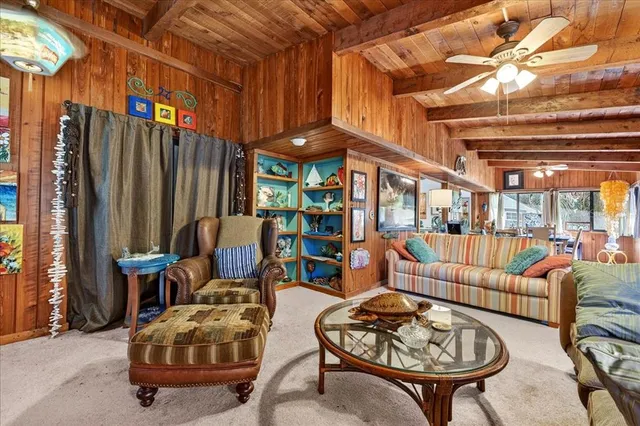a dining room with furniture and a floor to ceiling window