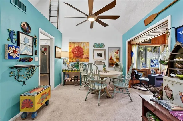 a view of an chairs and table in a room