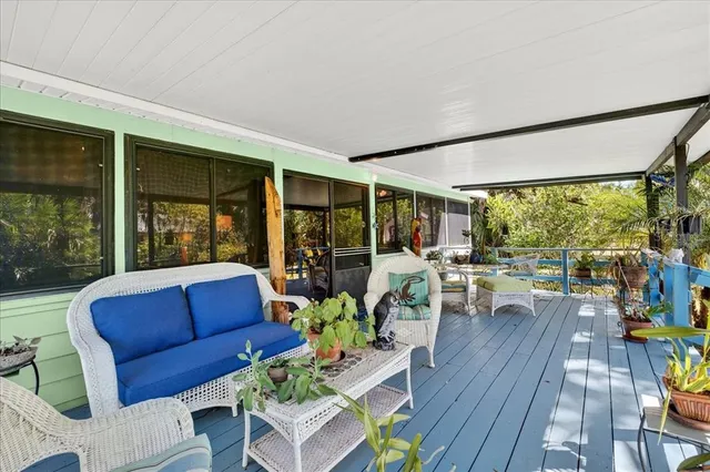 a living room with large windows and wooden floor