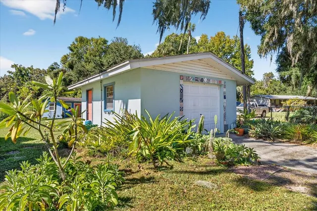 a view of a house with a yard and sitting area