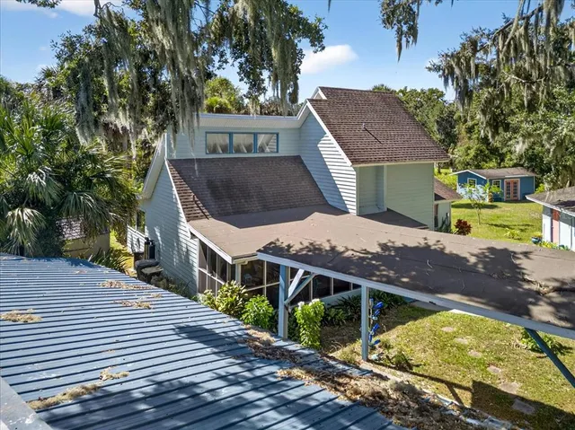 an aerial view of a houses with a yard