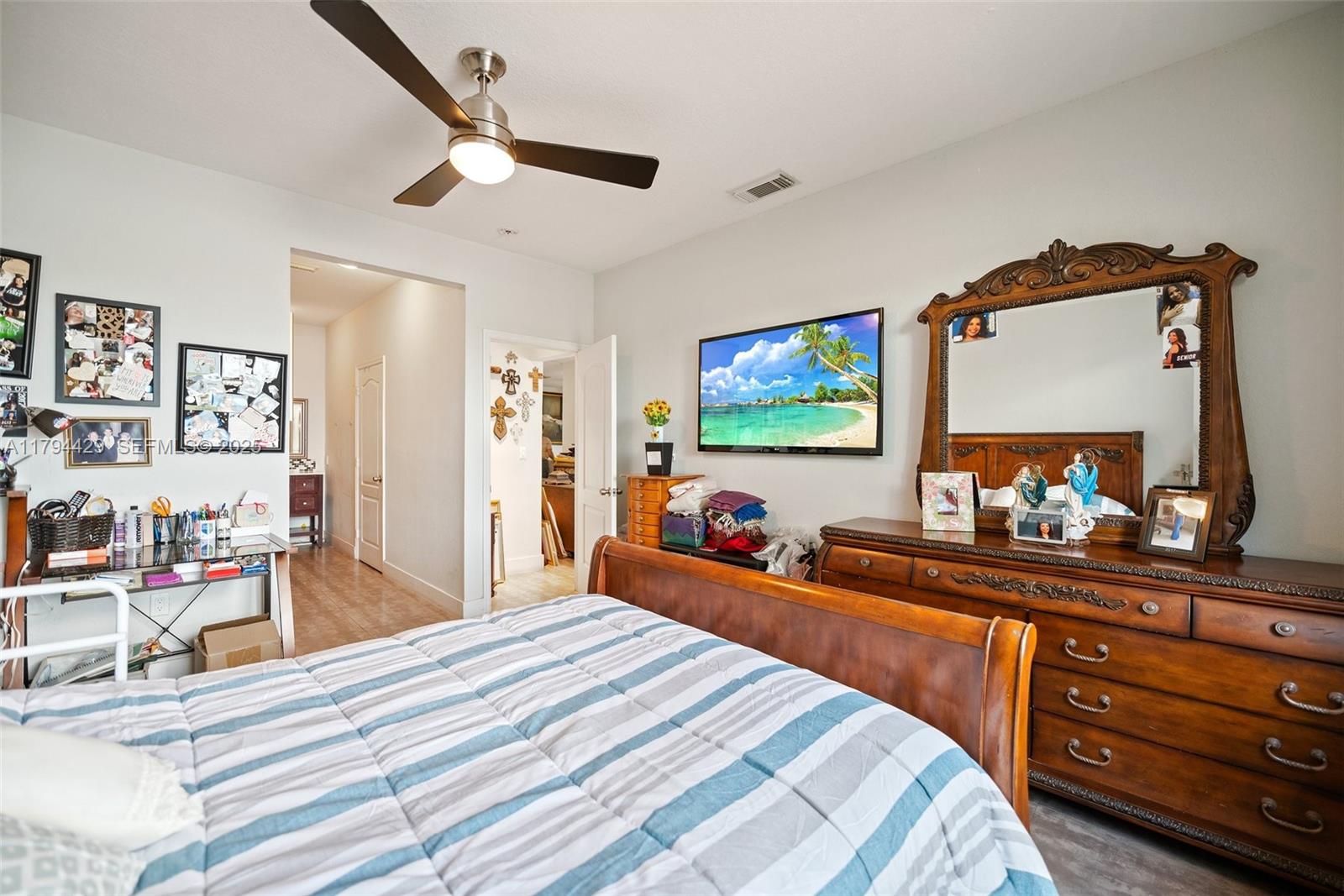 7045 Southwest 161st Place Miami, FL 33193 - Photo 19 of 33 a bedroom with a bed and a mirror on the dresser