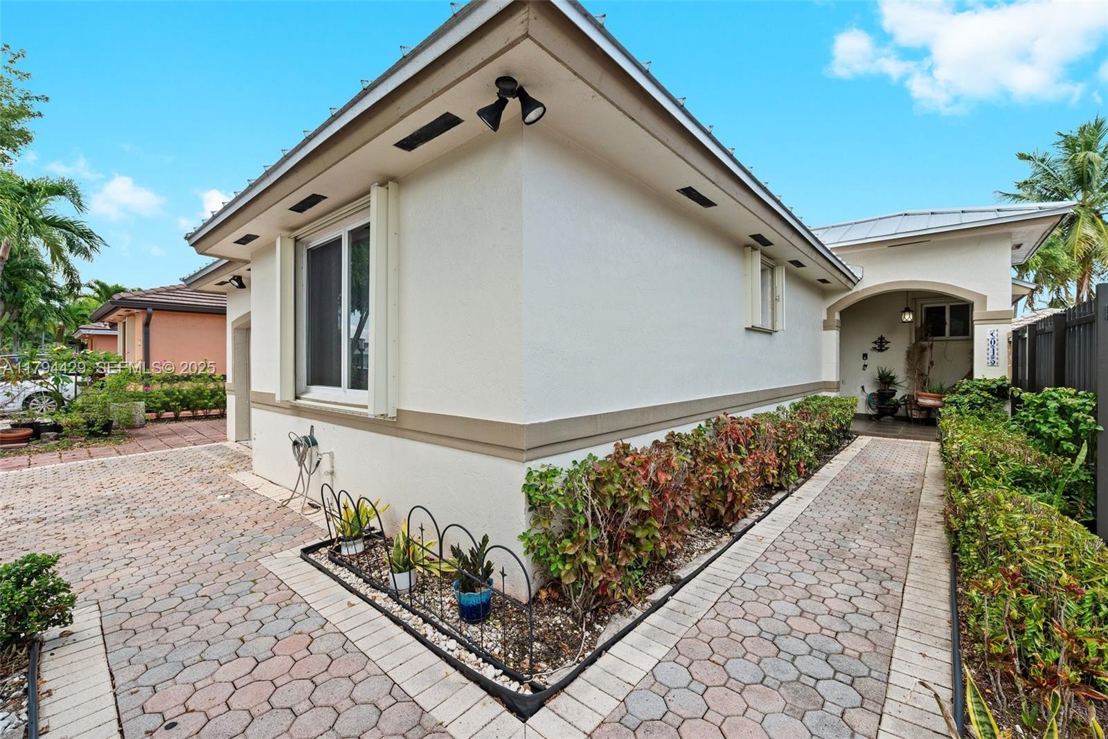 7045 Southwest 161st Place Miami, FL 33193 - Photo 2 of 33 a front view of a house with lots of trees in the background