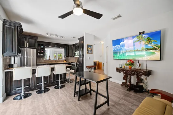 a view of a livingroom with furniture and a flat screen tv
