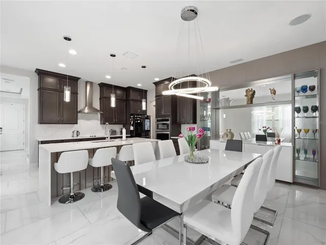 a large kitchen with a table and chairs