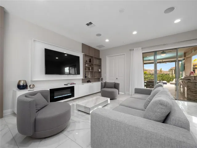 a living room with fireplace furniture and a flat screen tv
