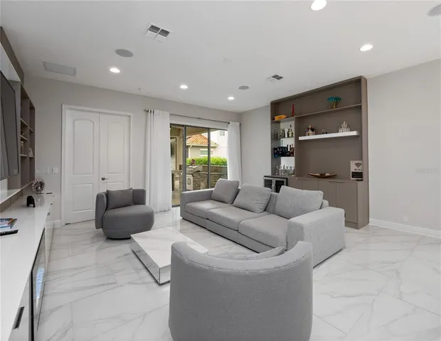 a living room with furniture window and a flat screen tv