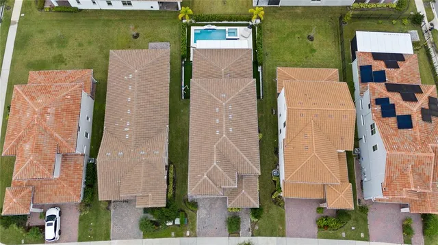 an aerial view of a house with a yard basket ball court and outdoor seating