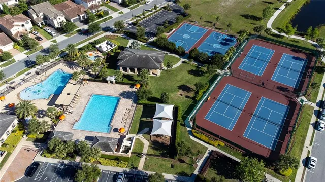 an aerial view of a house with a yard and outdoor seating