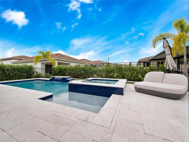 a view of swimming pool with seating space