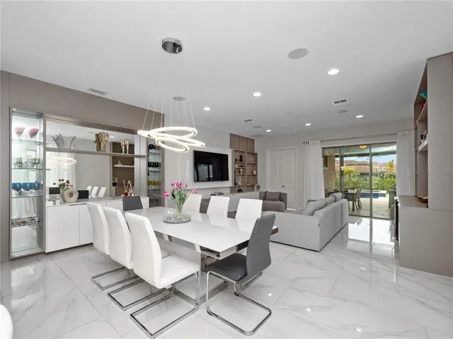 a living room with fireplace furniture and a large window