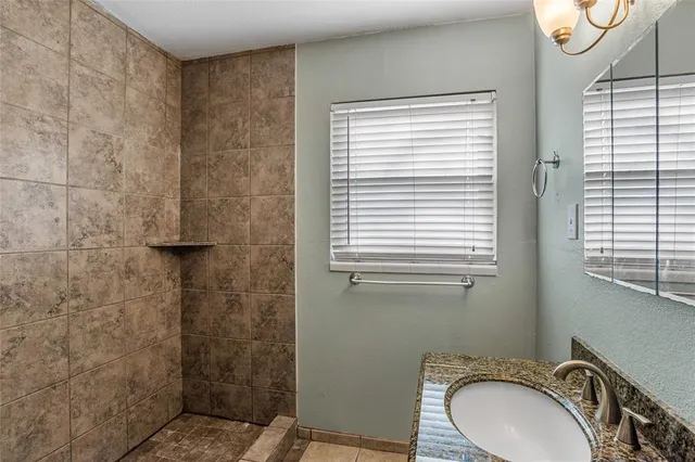 a bathroom with a sink a toilet and a window