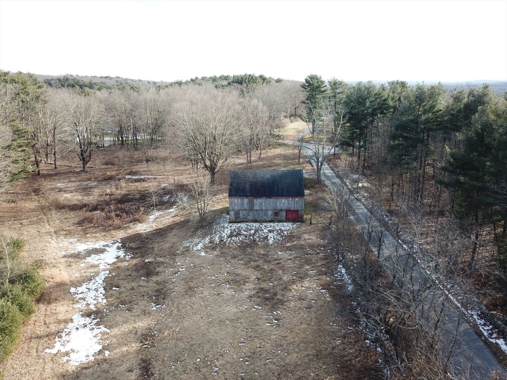 179 Upper Gore Road Webster, MA 01570 - Photo 28 of 42 a view of a dry yard with trees in the background