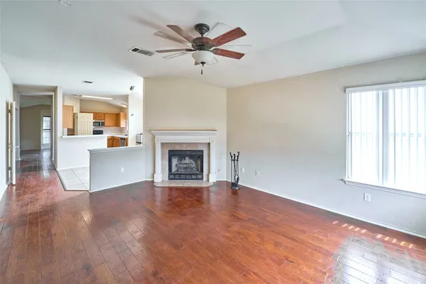 wooden floor in an empty room with a fireplace