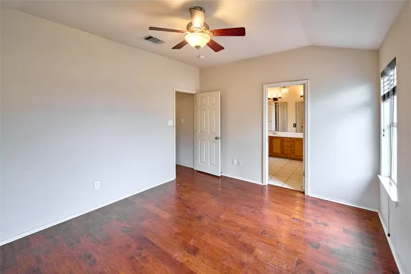 a large bathroom with a glass shower door and a sink