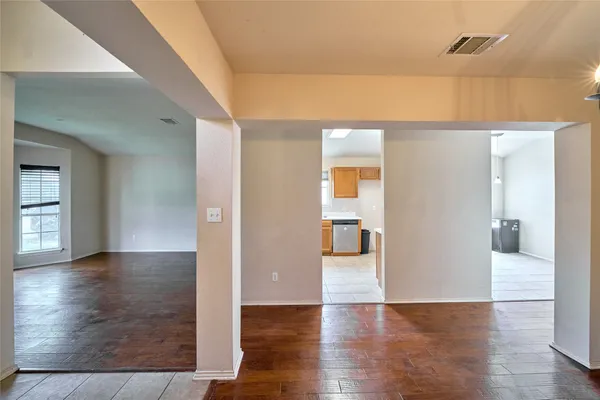 a view of a hallway with wooden floor