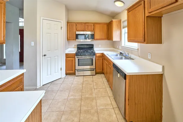 a kitchen that has a sink and a stove in it