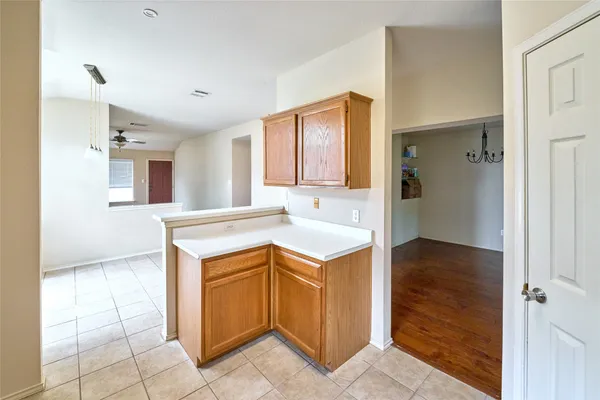 a kitchen with white cabinets and appliances