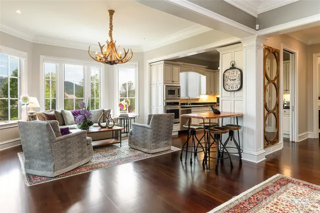a living room with fireplace furniture and a large window