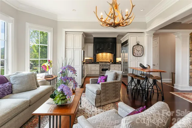 a living room filled with furniture and a large window