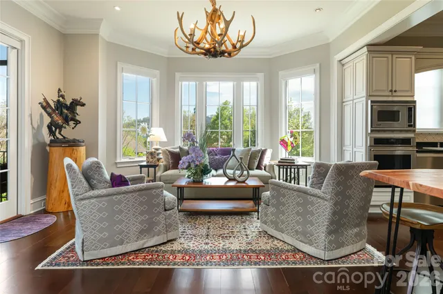 a living room with furniture and floor to ceiling windows