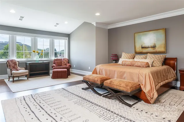 a bedroom with a bed a couch and a window