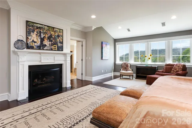 a living room with furniture a window and a fireplace