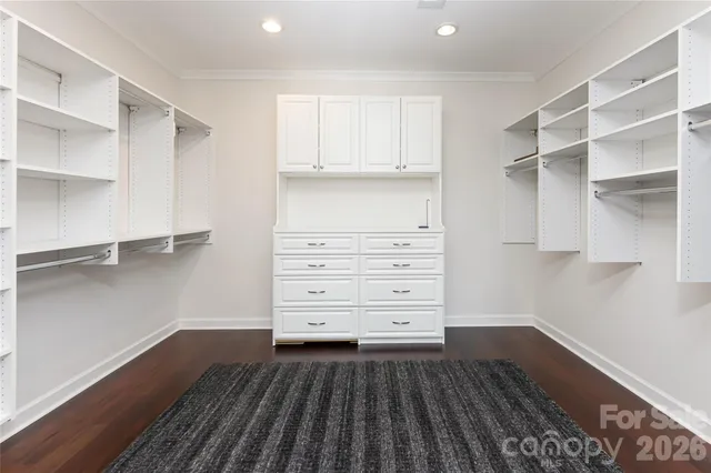 a view of walk in closet with empty racks