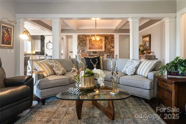 a living room with furniture wooden floor and a large window