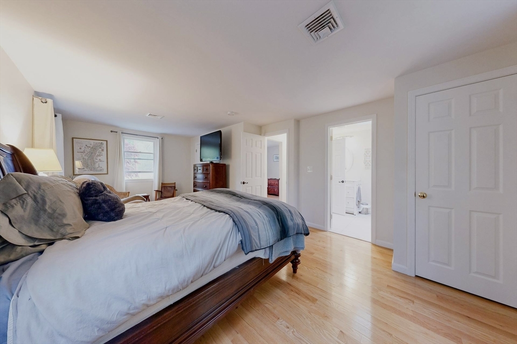 2 Russett Road Bedford, MA 01730 - Photo 18 of 41 a spacious bedroom with a bed and wooden floor