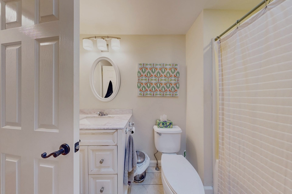 2 Russett Road Bedford, MA 01730 - Photo 20 of 41 a bathroom with a toilet sink vanity tub and mirror