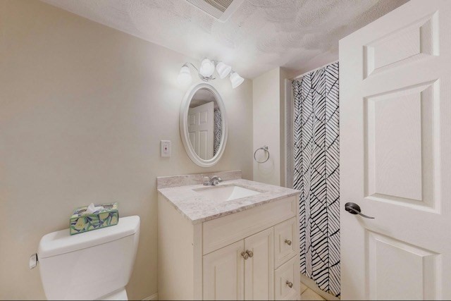 2 Russett Road Bedford, MA 01730 - Photo 24 of 41 a bathroom with a granite countertop sink a toilet and a mirror