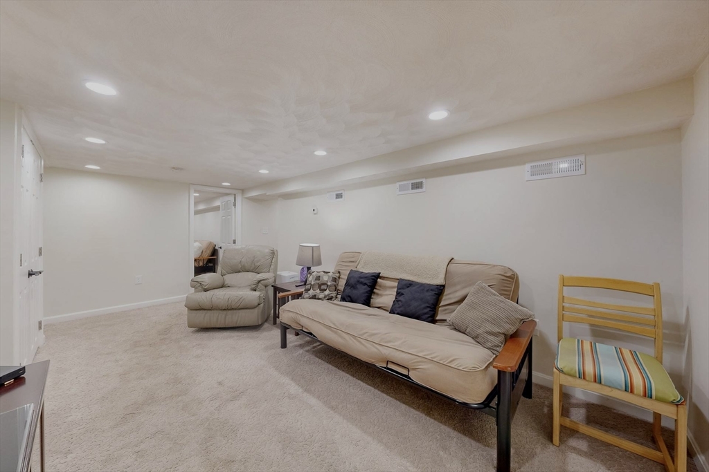 2 Russett Road Bedford, MA 01730 - Photo 26 of 41 a living room with furniture and a flat screen tv