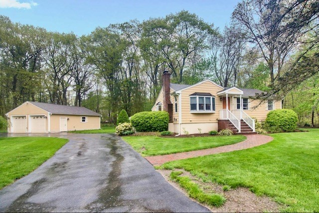 2 Russett Road Bedford, MA 01730 - Photo 3 of 41 a front view of a house with a yard and trees