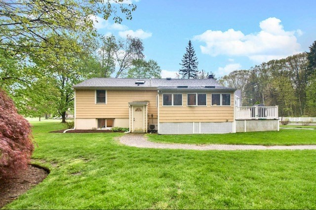 2 Russett Road Bedford, MA 01730 - Photo 40 of 41 a front view of a house with a yard table and chairs