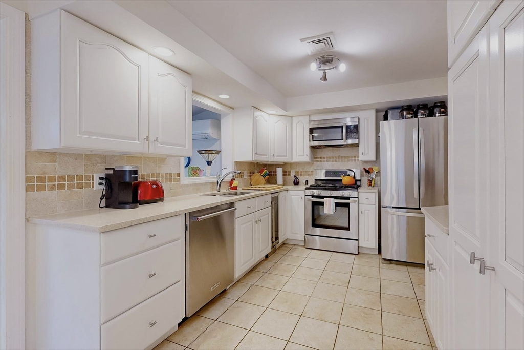 2 Russett Road Bedford, MA 01730 - Photo 10 of 41 a kitchen with cabinets and stainless steel appliances