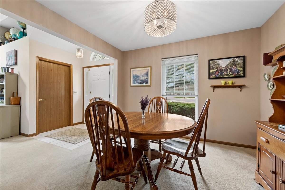 2110 Peach Tree Lane, Unit 2110 Algonquin, IL 60102 - Photo 11 of 21 a view of a dining room with furniture window and wooden floor
