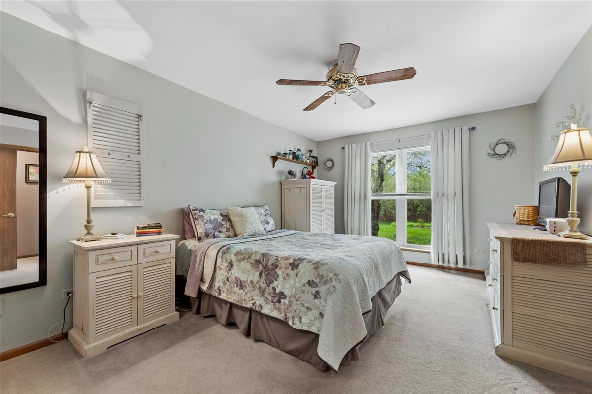 2110 Peach Tree Lane, Unit 2110 Algonquin, IL 60102 - Photo 13 of 21 a bedroom with a bed and a chandelier