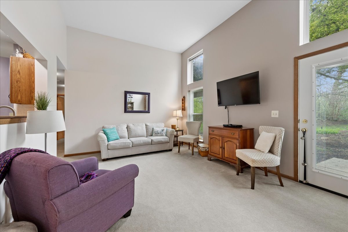 2110 Peach Tree Lane, Unit 2110 Algonquin, IL 60102 - Photo 5 of 21 a living room with furniture and a flat screen tv