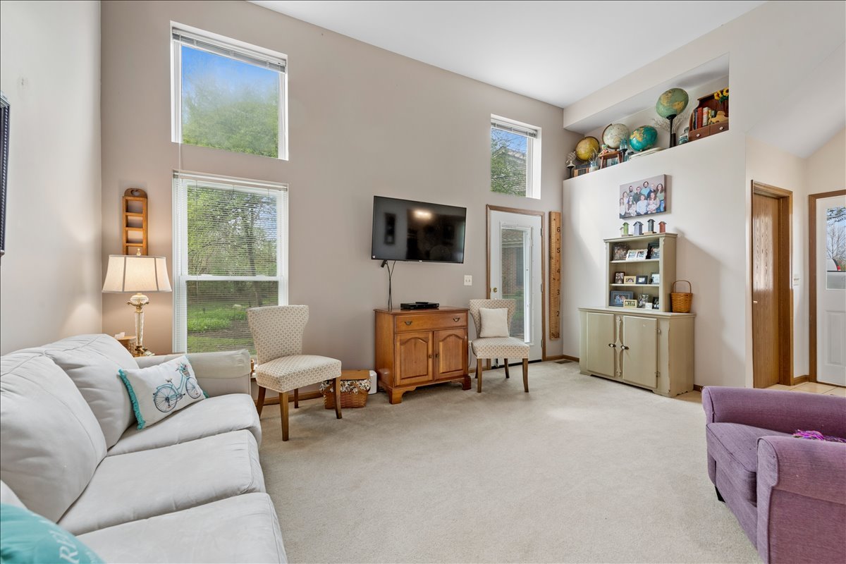 2110 Peach Tree Lane, Unit 2110 Algonquin, IL 60102 - Photo 6 of 21 a living room with furniture and a flat screen tv