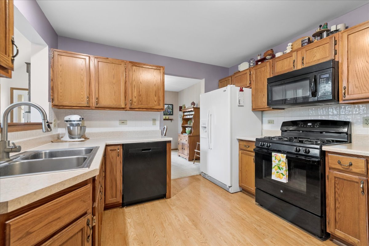 2110 Peach Tree Lane, Unit 2110 Algonquin, IL 60102 - Photo 8 of 21 a kitchen with stainless steel appliances granite countertop a stove a sink dishwasher a refrigerator and a microwave oven