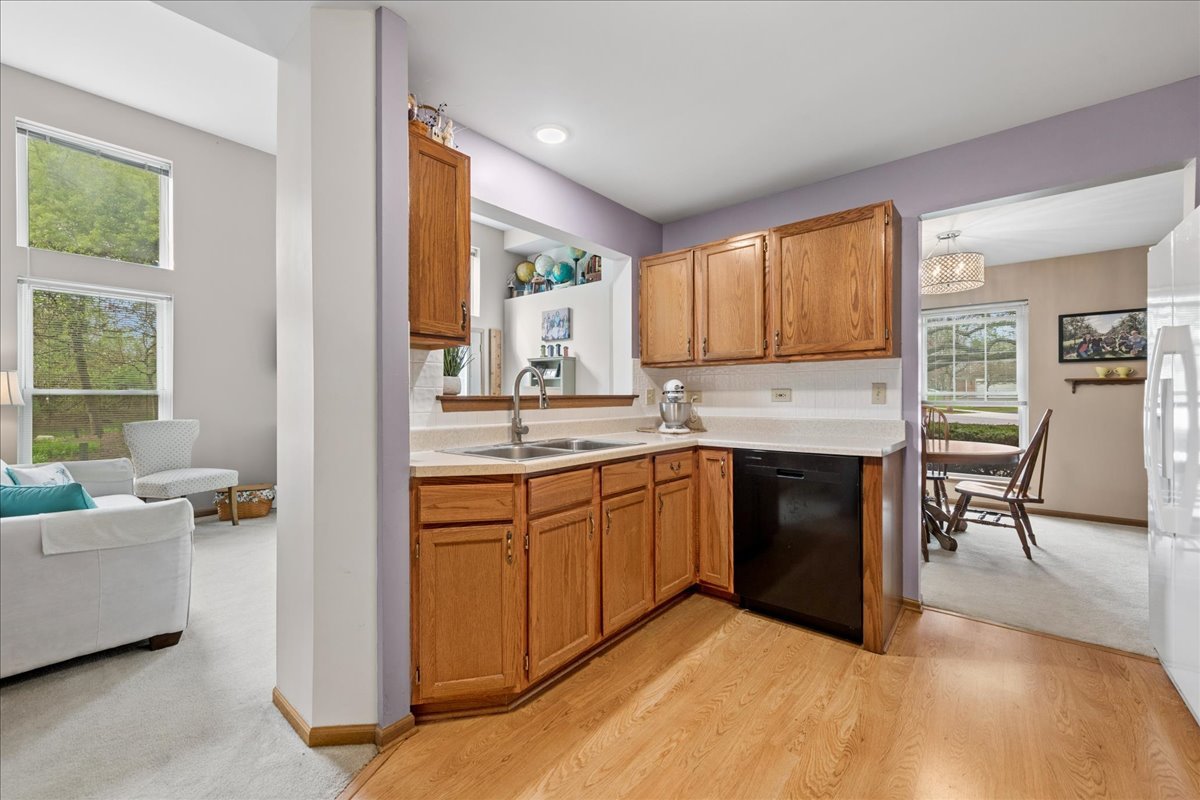 2110 Peach Tree Lane, Unit 2110 Algonquin, IL 60102 - Photo 9 of 21 a kitchen with a sink cabinets and window