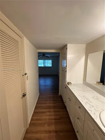 a view of a room with wooden floor