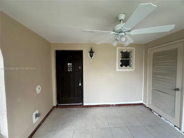a view of an empty room with a ceiling fan
