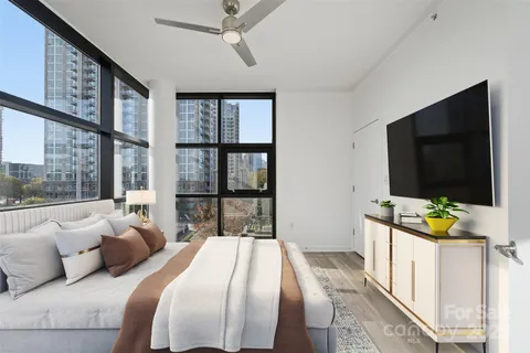 a bedroom with bed and a flat screen tv