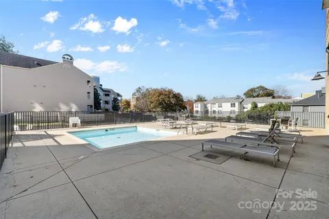 a roof deck view with a couch and chairs
