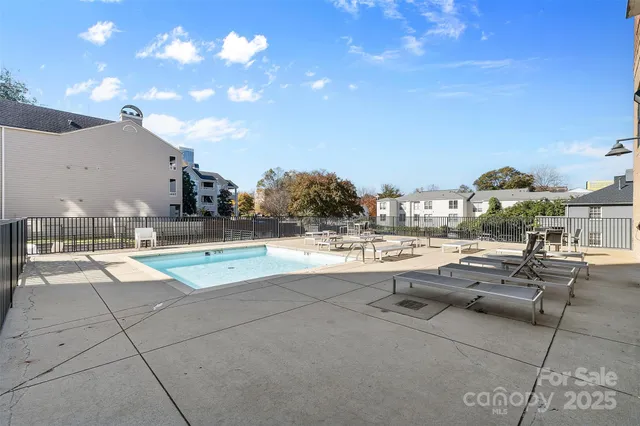 a roof deck view with a couch and chairs