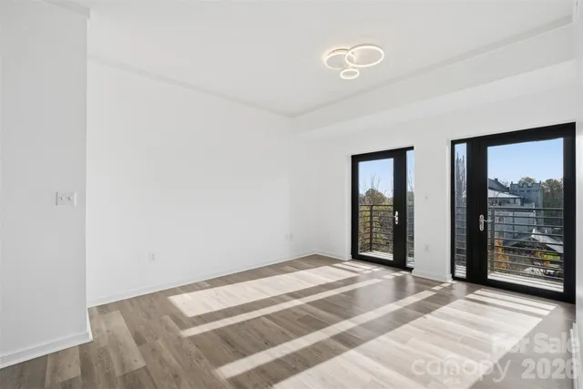 a view of an empty room with glass door
