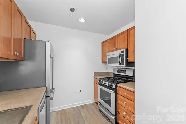 a kitchen with stainless steel appliances granite countertop a stove and a refrigerator